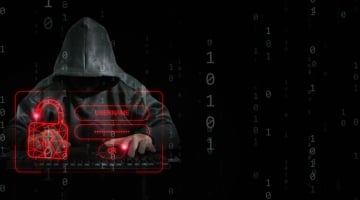 Hooded hacker at keyboard attempting brute-force login attack, with red digital lock and username/password fields overlaid on binary code background.