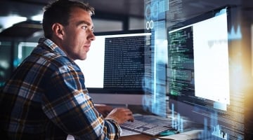 Image of security analyst focusing on computer screen