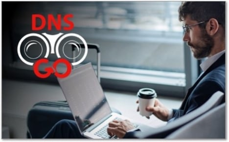 DNSWatchGO icon in front of a man in an airport using his laptop