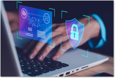 hands on a laptop with floating security symbols on tiles in front of the screen