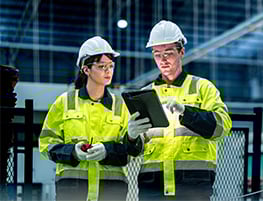 Man and a woman in hi-vis jackets and safety gear