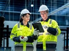 Man and a woman in hi-vis jackets and safety gear