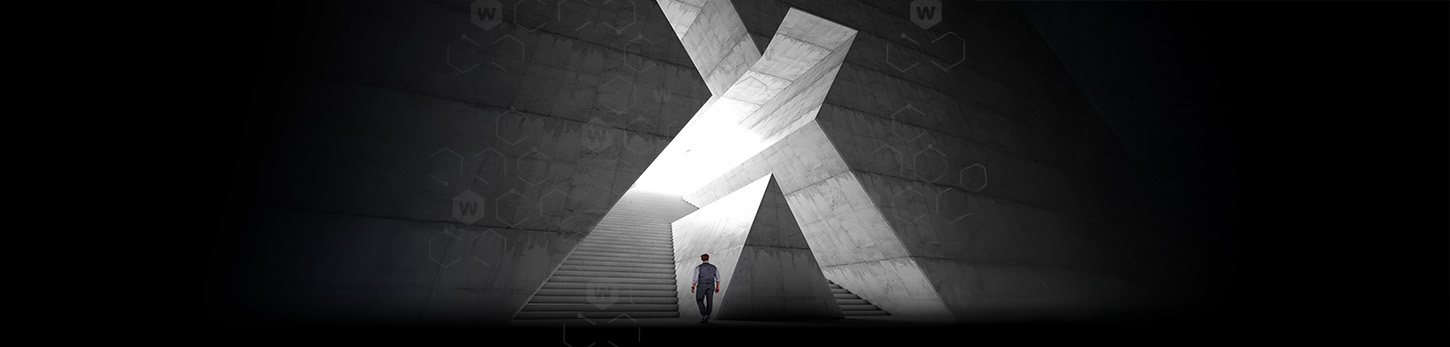 Man walking towards large X-shaped staircase 